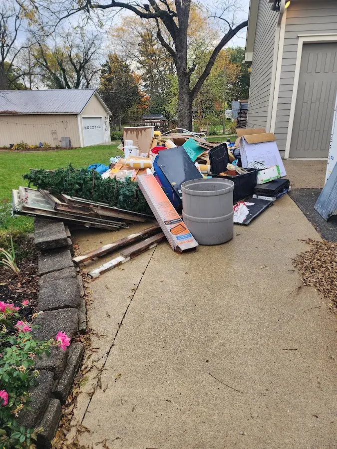 Dumpster being loaded with debris for Roofing Dumpster Rental in Sturgeon Bay